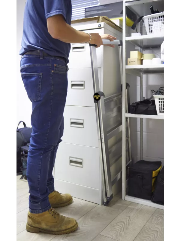 Person using aluminium folding step ladder to reach top shelf in office storage area.